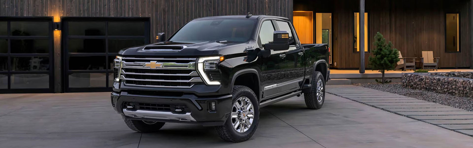 Black Chevrolet Silverado 2500 parked outside a home.